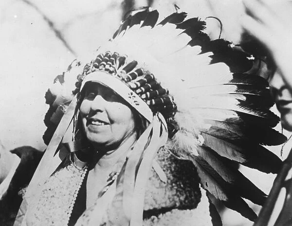 Queen of Romania wearing the war bonnet presented by a Sioux Chief. 16 November 1926