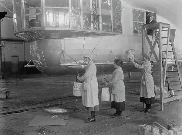 R36 Ready for launching at Inchinnan Woman workers placing ballast bags on the airship 19