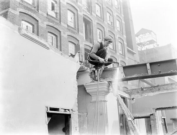 The redevelopment of the Erith riverside, London. A welder with a blow torch. 1937