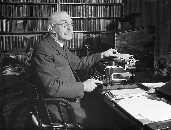 The Reverand Mackintosh of Horns Cross, Kent, sitting at his typewriter
