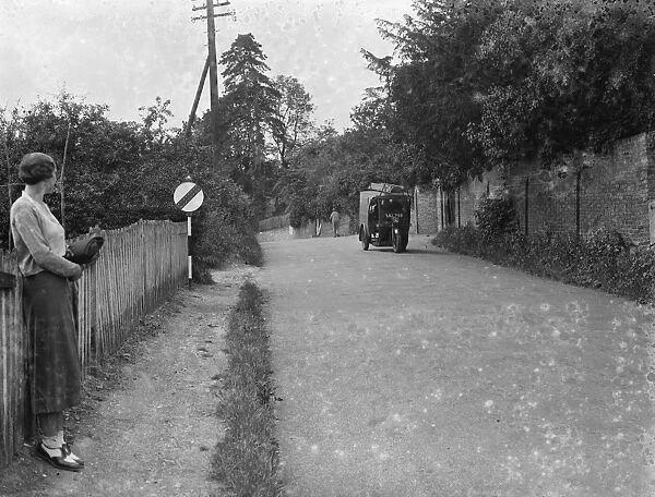 Road with a traffic sign at Farningham, Kent. 1935