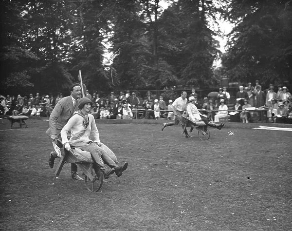 Roehampton Club Pony Gymkhana Lord Blandford and Lady Warrender in the wheelbarrow