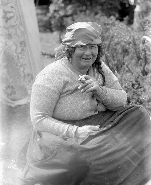 A Romany gypsy woman smoking her pipe at the Epsom Races. Late 1940s, early 1950s