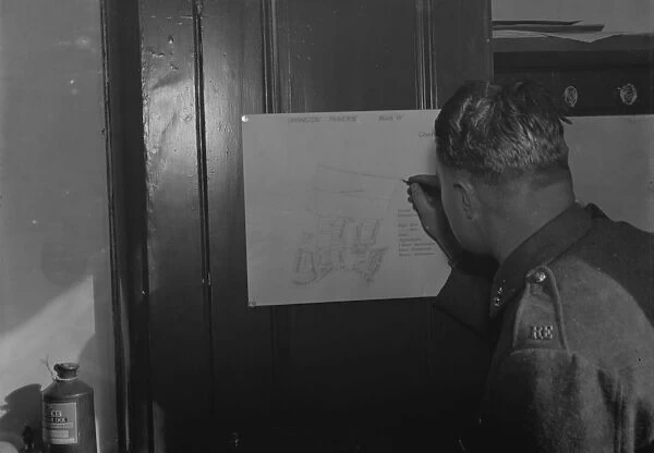A Royal Engineer soldier drawing survey maps from notes and memory. 1937