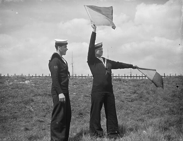 Royal navy reserve volunteers in camp at Greenhithe. A signalman learns Flag