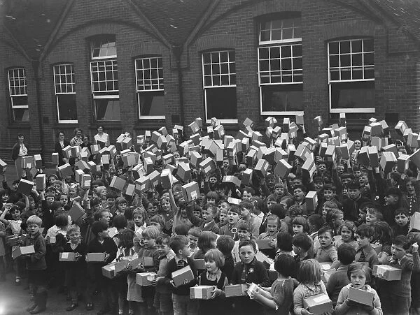 School children at Sidcup Hill School, Kent, wave the boxes containing their coronation