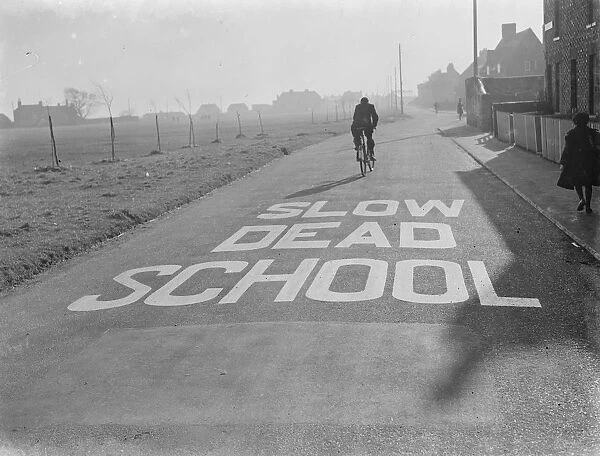 A school sign painted on the road warning road users they are approaching a school area