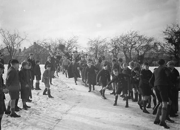 Schoolboys sliding on the snow in Orpington, Kent. 1937