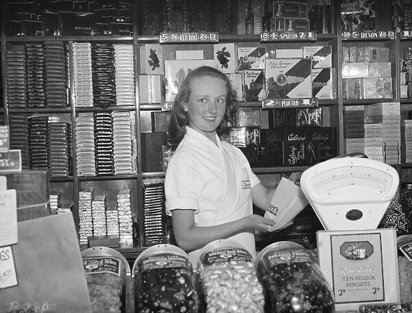 Sidcups beauty queen winner, Miss Jennie Boyles at work in the sweet shop. 1938