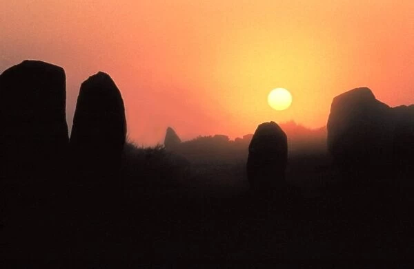The silhouette of menhirs in the landscape at dawn, Carnac, Morbihan, Southern Brittany