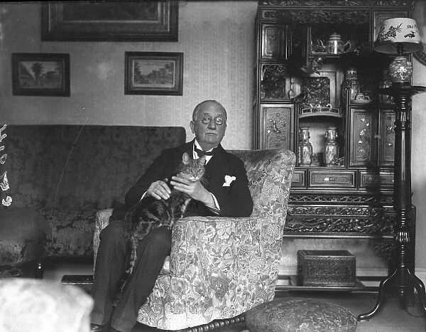 Sir Frederick Bridge, conductor and organist, at his home, Little Cloisters