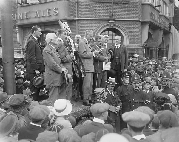 Sir Harry Mallaby Deeley opened the famous Mitcham Fair. He is seen reading the