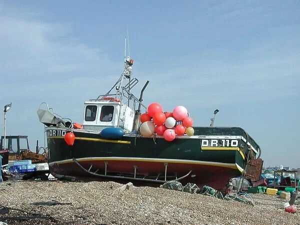 Small fishing boat with colourful buoys and lobster-pots, Walmer beach, Kent, England