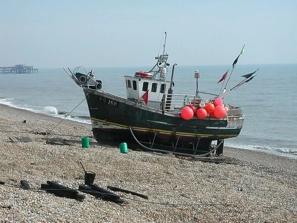 Small fishing boat moored on seashore, Walmer, Kent, England