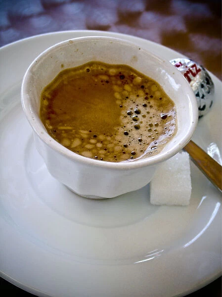 Small handleless cup of strong Turkish coffee on cafe table credit: Marie-Louise