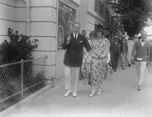 Society at Deauville. Mr Jeff Cohn, the famous racehorse owner, strolling with his wife