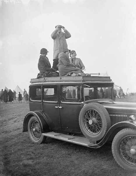 Spectators climb on to the roof of their car to get a good view of the R A Woolwich