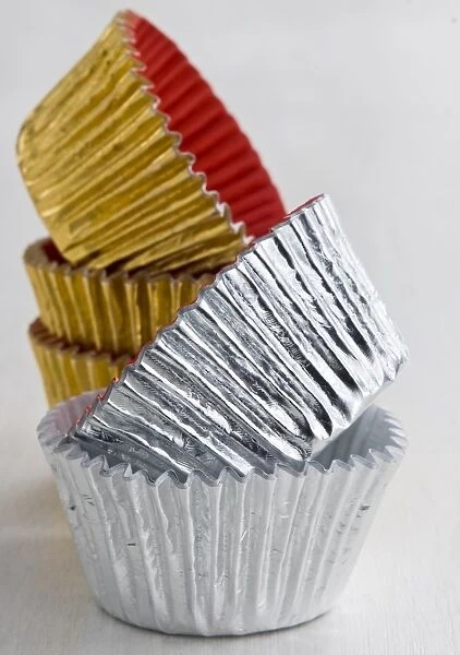 Stack of decorative metallic foil cake and muffin cases credit: Marie-Louise Avery