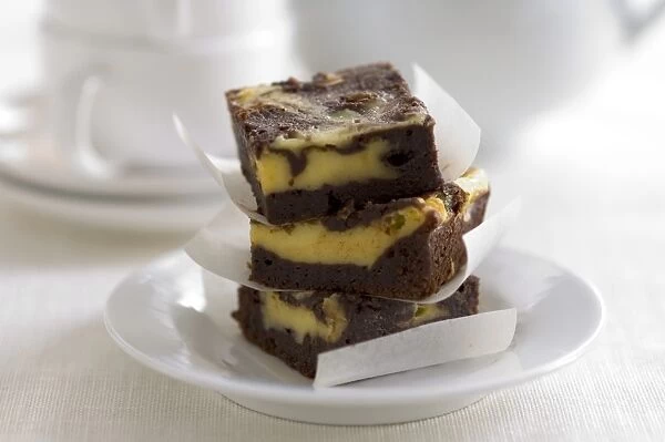 Stacked squares of cheesecake marbled with chocolate credit: Marie-Louise Avery