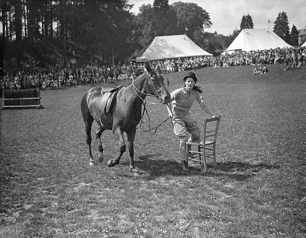Staking Her Claim ! Photo Shows : Leading her poney, a girl rider eagerly lays