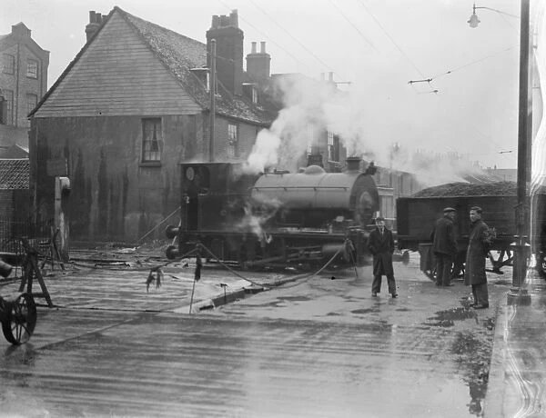 A steam train pass by through the level crossing in Westwood Erith, London, where