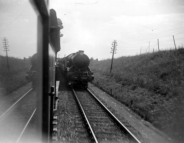 Two steam trains pass each other. 1933