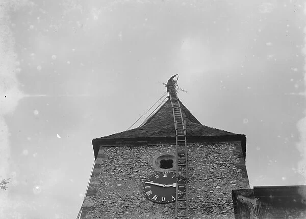 A steeplejack at work on top of St Mary Cray church tower. 1935