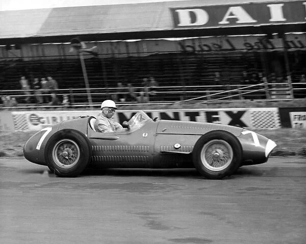 Stirling Moss driving a Maserati during a practice for the Grand Prix that takes