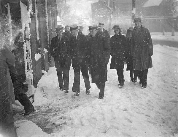 Straw hats in the snow. A peculiar contrast in the snow as the straw hatted schoolboys