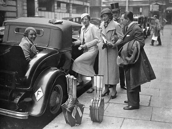 Suzanne Lenglen with a dozen tennis rackets off for a day in the country. Mademoiselle