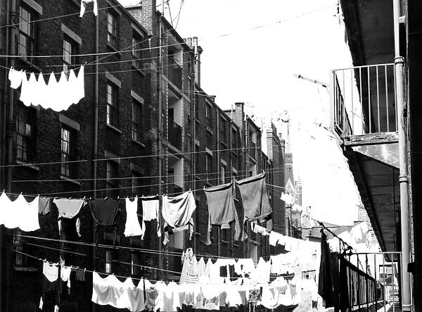 Tenements in St Pancras, London with laundry hanging from washing lines strung