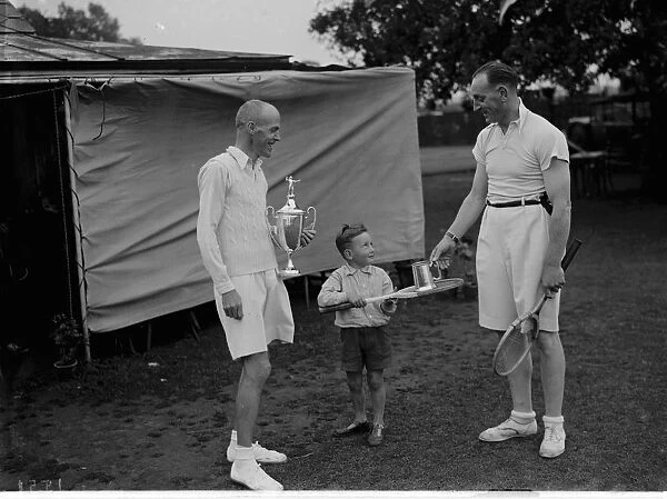 Tennis finalist at Bromley being handed their trophies by a child. 1935