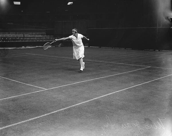 Tennis stars shine at Wimbledon. Miss Joan Fry, one of the British hopes, making