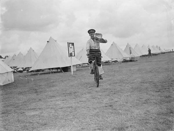 Territorial Army recruits at camp in Chichester, Sussex. Fetching water on a bicycle
