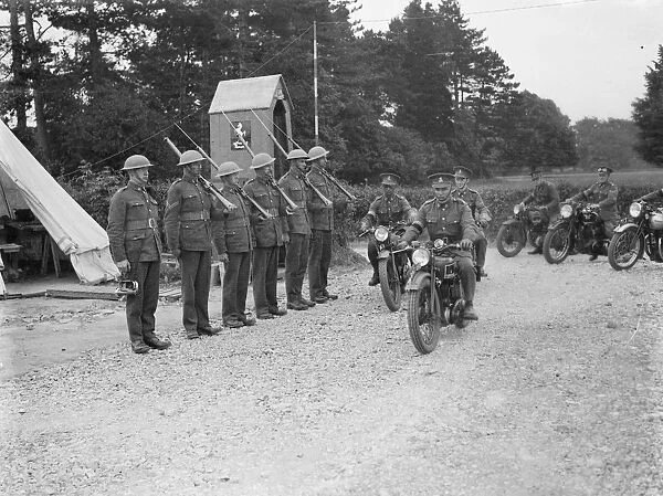 Territorial Army recruits at camp in Chichester, Sussex. Motorcyclists ride past