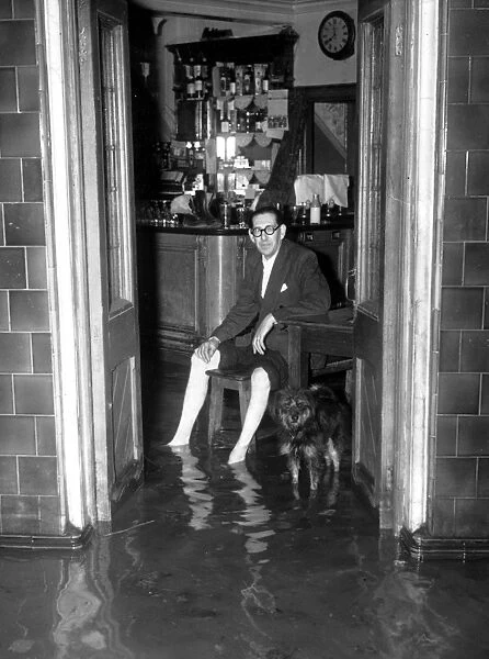 Thames Floods At Belvedere licensee of the Belvoir sits in his bar and watches the