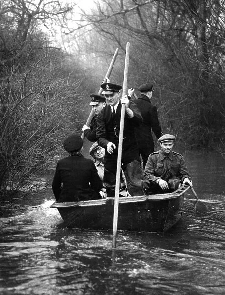 Thames Floods. Police of the Metropolitan River Squad brought a portable boat