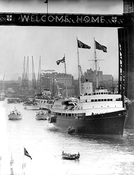 Under Tower Bridge- and the Welcome Home sign - passes the majestic looking Britannia