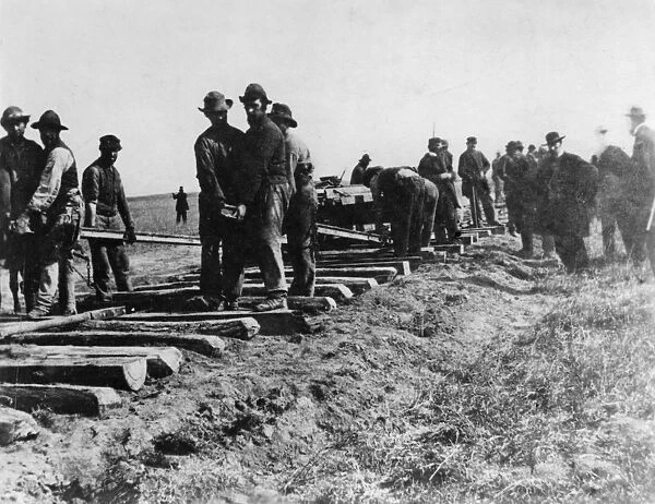 Track crew laying the track photographed at the 100th Meridian Photo by Carhutt