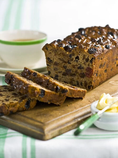 Traditional style fruit tea loaf sliced and served with butter and afternoon tea credit