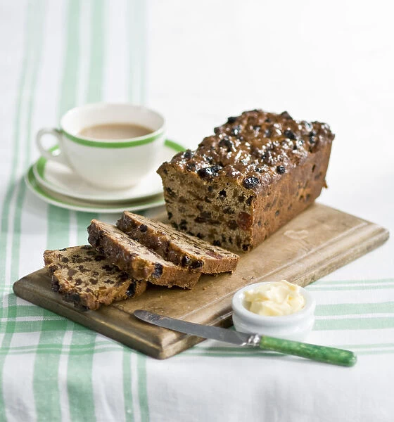Traditional style fruit tea loaf sliced and served with butter and afternoon tea credit