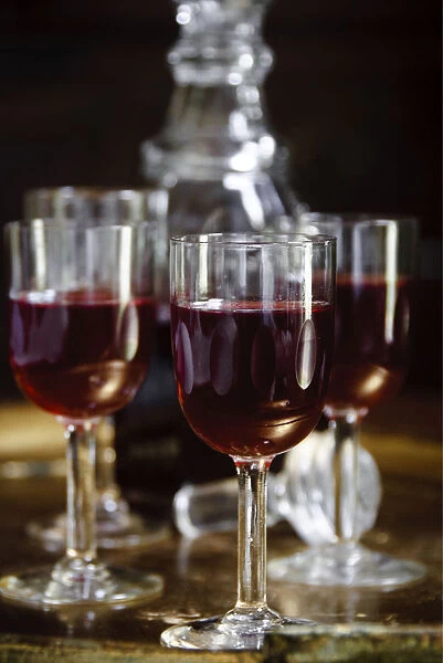 A tray of glasses of sloe gin with unstoppered decanter. credit: Marie-Louise Avery