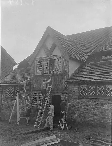 Tudor building collected from all parts of the country. Scouts build own quarters at Godstone