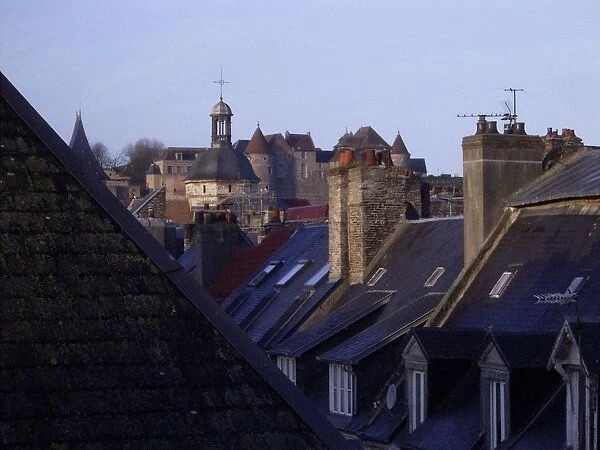 Typical French rooftops and chimneys after the rain, the slate tiles looking a dark