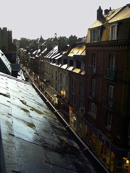 Typical French town houses with wet rooftops glistening in a golden light after rain