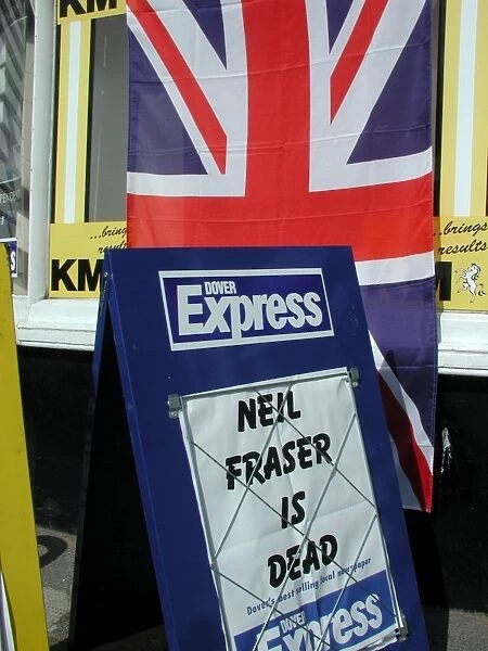 Union Jack flag outside a newsagents shop with a board announcing that local murderer
