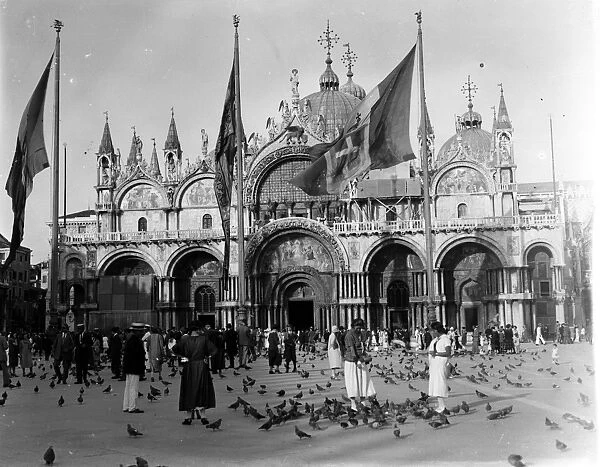 Venice; St Marks Basilica in St Marks Square with pigeons and tourists
