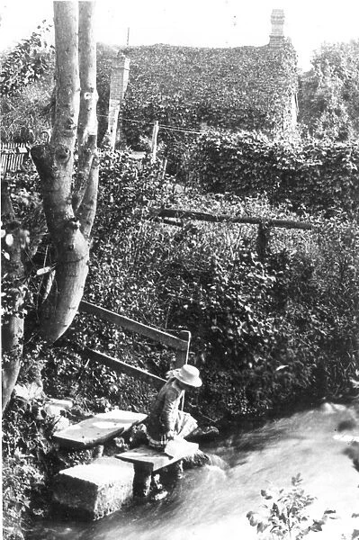 A Victorian girl fetching water from a stream at the bottom of the garden