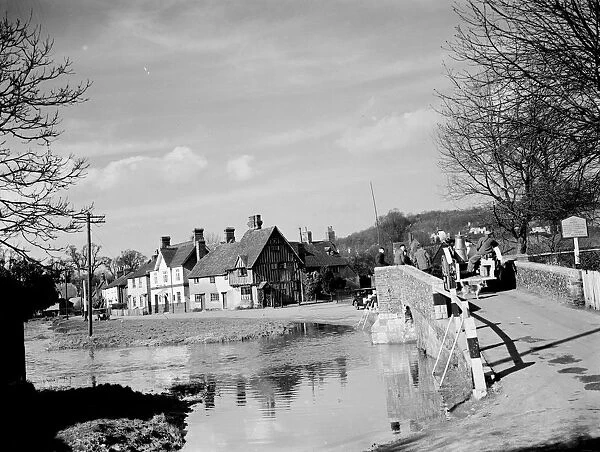 A view of Eynsford over the River Darent with a milk cart going over the bridge