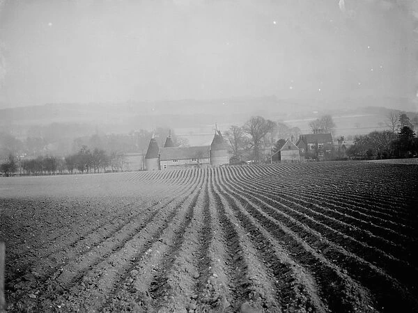 A view over a ploughed field to an Oast house at Otford in Kent. 1938